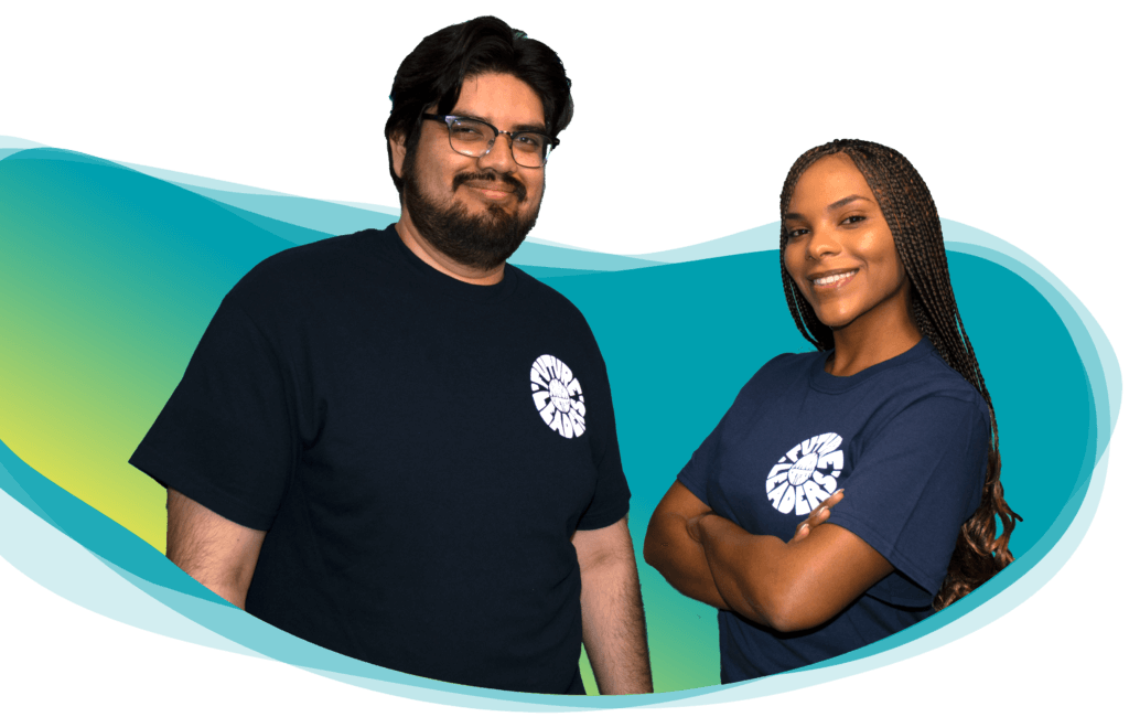 Two people wearing blue shirts with a graphic on the front